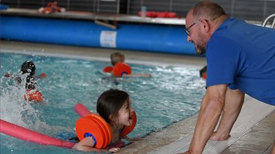 Be Well swimming instructor with young girl in pool