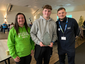 Daniel, mum and Chris Hewitt at a Be Well celebration event for participants, Hindley Pavilion, December 2023