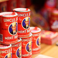 Stack of tins of Uncle Joe's mint balls on a shelf