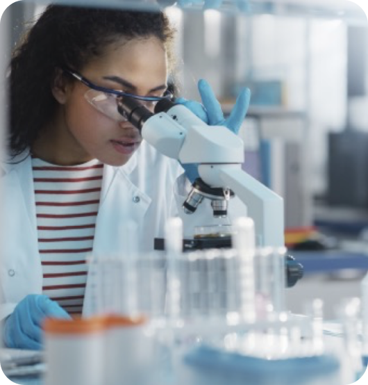 A scientist looking into a microscope